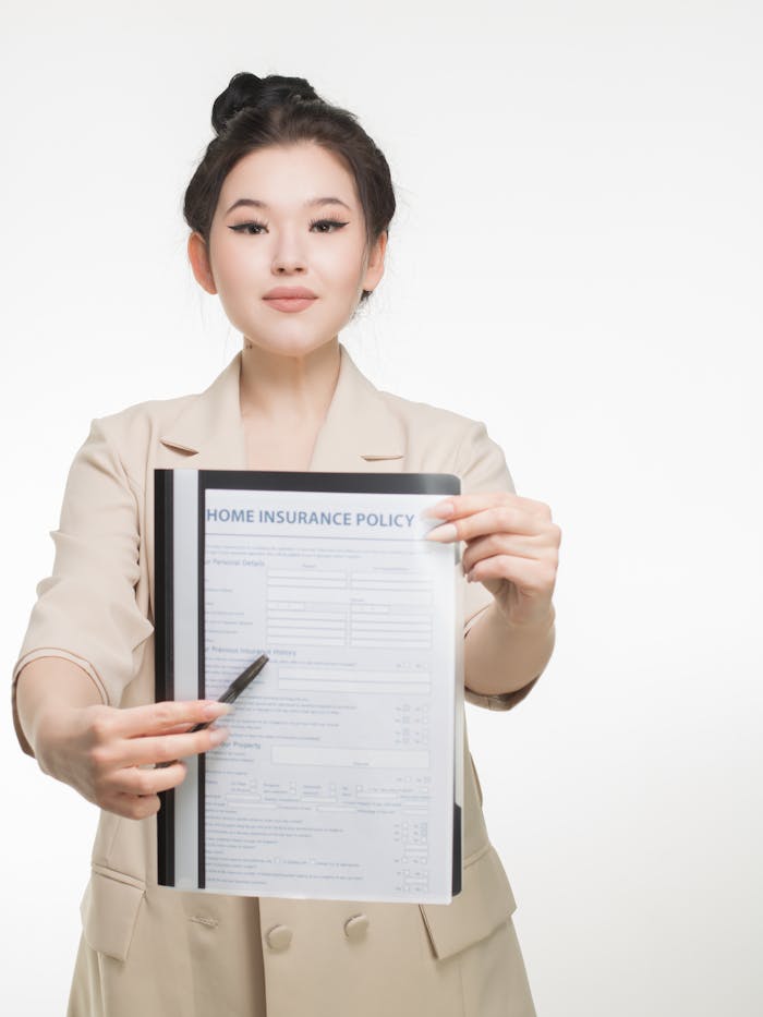 why-choose-us Professional woman showcasing a home insurance policy document with confidence and clarity.